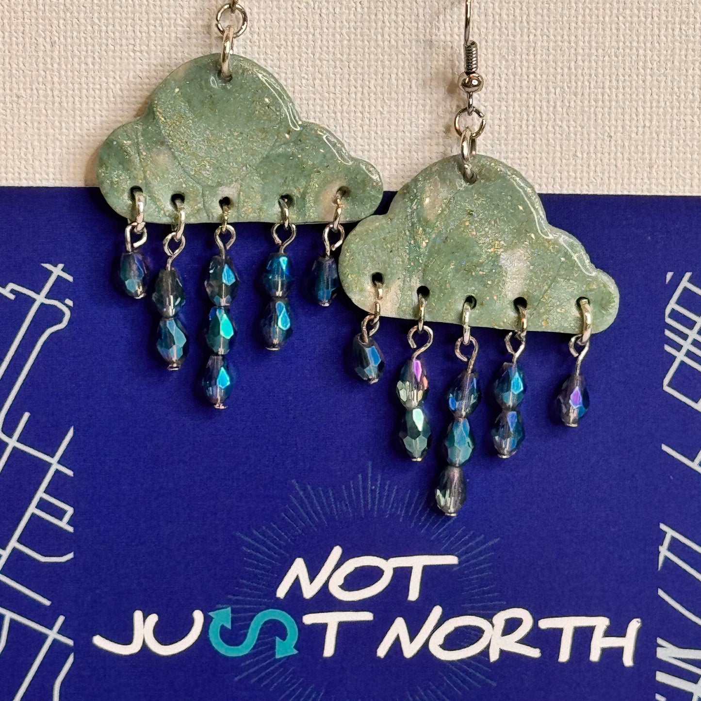 Turquoise Rain Clouds with Saphire Blue Teardrop Glass Beads Resembling Rain Drops in Staggered Tiers with Brand Place card