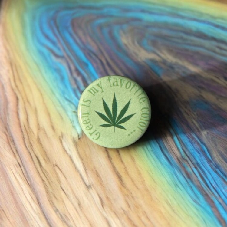 Round button saying green is my favorite color with a green marijuana leaf in the center.
