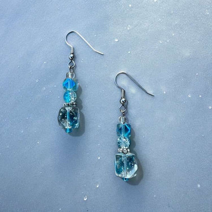 Light blue cubed beads stacked on top of each other to form dangle earrings.