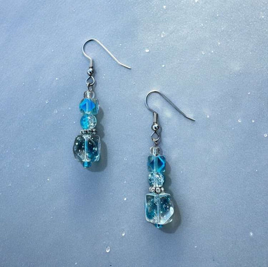 Light blue cubed beads stacked on top of each other to form dangle earrings.