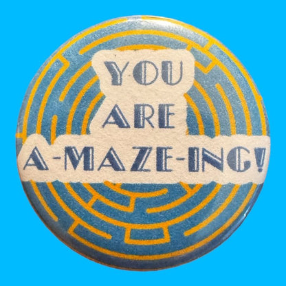 Round button saying amazing sits in the center of the button. A yellow maze on a blue background sit behind the wording.