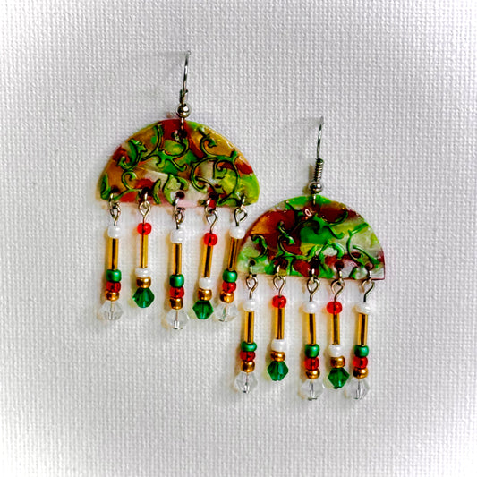 Festive Holly Jolly Charm earrings featuring handcrafted polymer clay holly leaves, vibrant red glass beads, and a holiday-inspired design. Perfect handmade earrings for holiday parties, gifting, or adding seasonal cheer to your look.