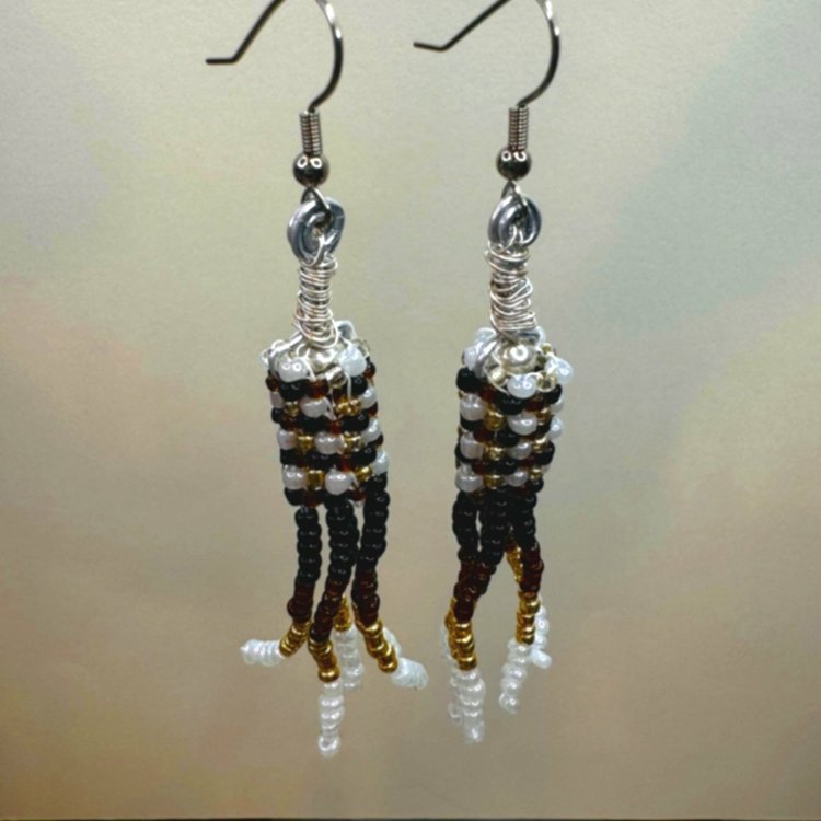 Brown, Black, White, and Gold beads woven together form a cylinder and have stacks of beads hanging down, making a chandelier style earring.